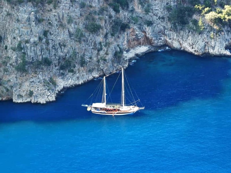 Fethiye: Island Sailing Trip with Lunch and Hotel Pickup - Dockyard Island and shoreline ruins you can spot between swims