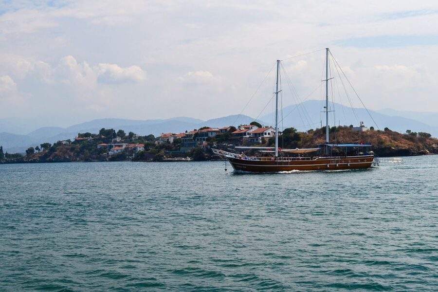 Fethiye: Island Sailing Trip with Lunch and Hotel Pickup - Red Island: clear water over red ground that looks different up close