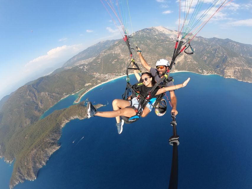 Fethiye: Tandem Paragliding Experience w/Hotel Pickup - Landing on the sandy beach, then the photo upsell question